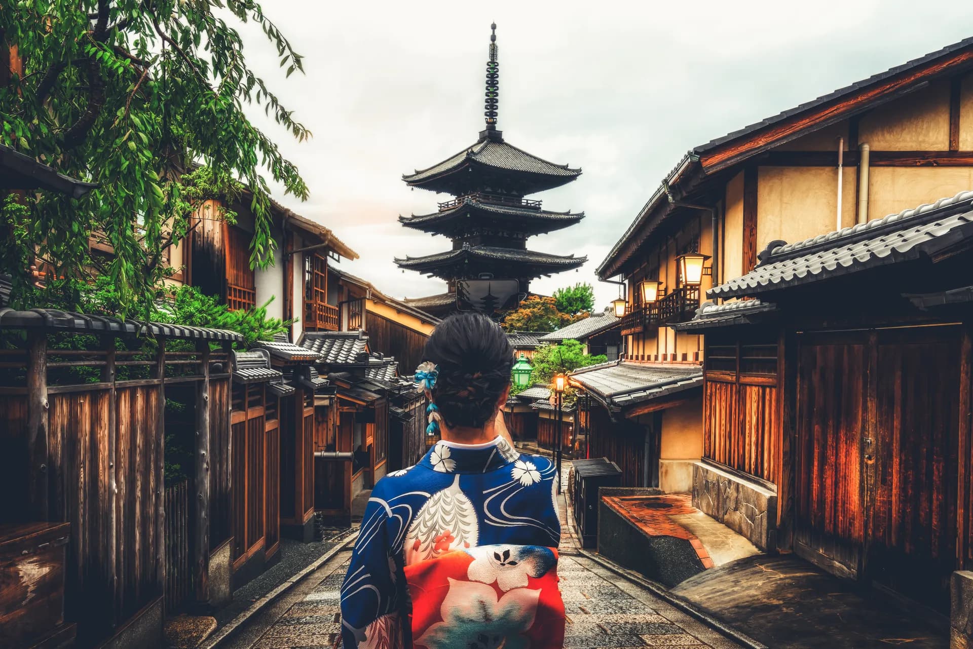 Traveler in traditional kimono walking through historic Higashiyama district in Kyoto