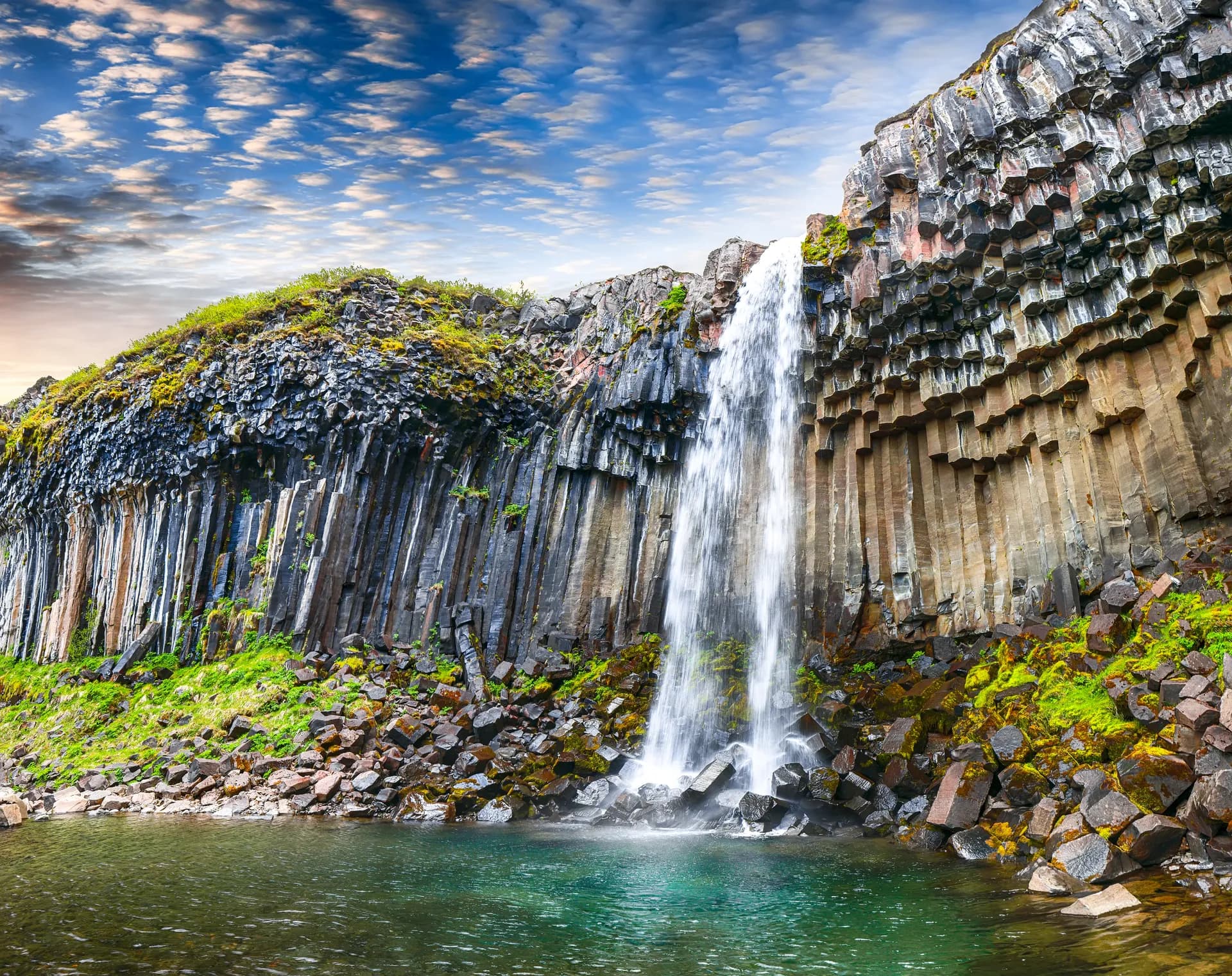 Svartifoss waterfall framed by dark basalt columns in South Iceland