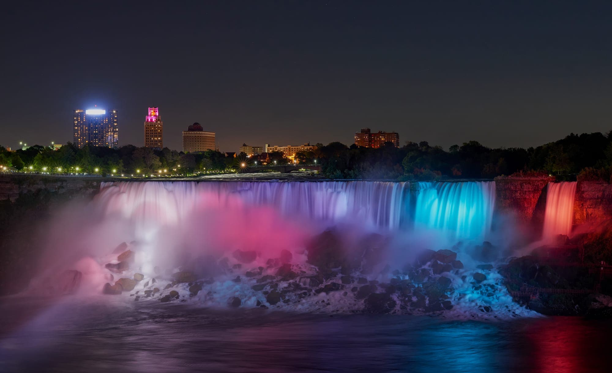 Niagara Falls illuminated with colourful lights at night